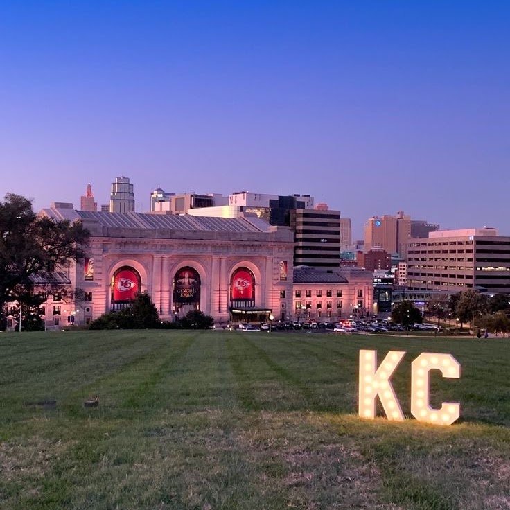Union Station in Kansas City lit at night with the KC letters glowing on the lawn.